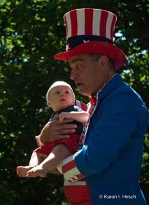 Uncle Sam dressed in red, white and blue holding baby