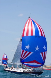 Sailboat with  red, white and blue spinnakers at start of Race to Mackinac