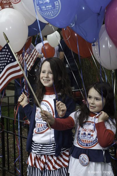 Two girls with American flags in Woogm Parade